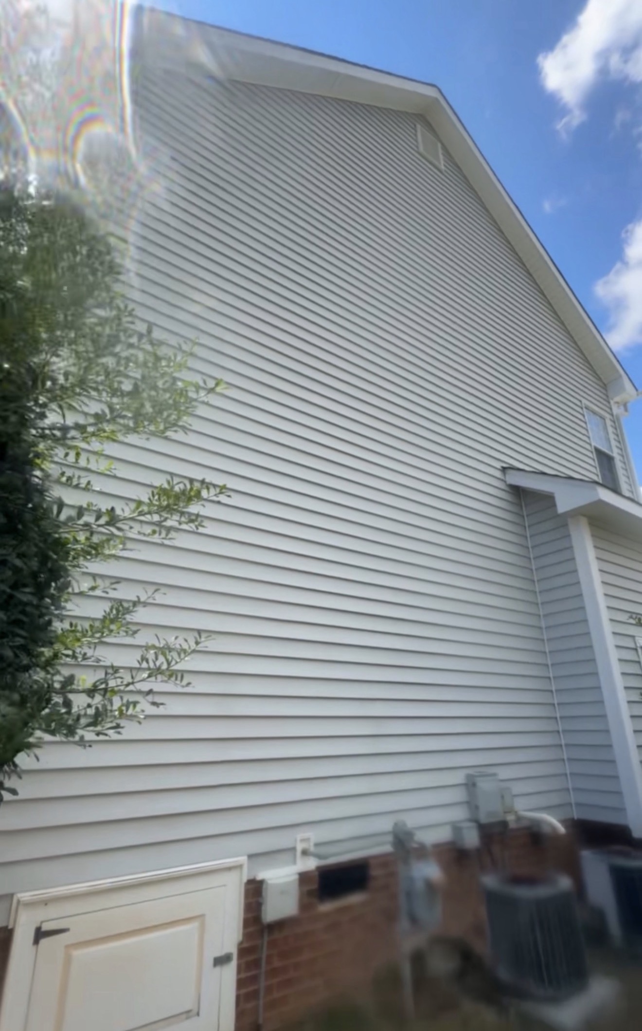 Sparkling clean white siding after house washing by Green Eagle