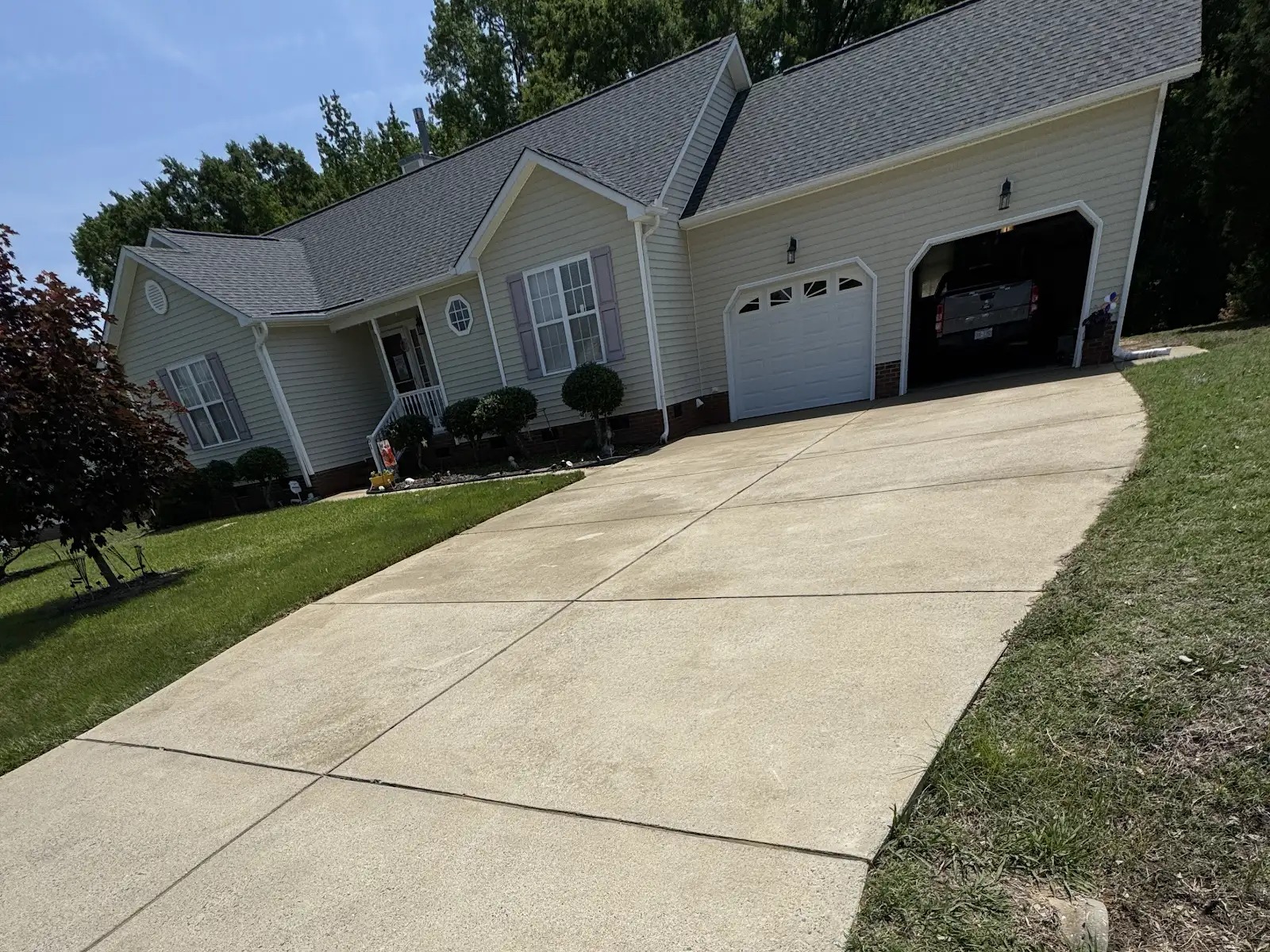 Concrete driveway and front walkway cleaned in a Cary NC neighborhood after house washing