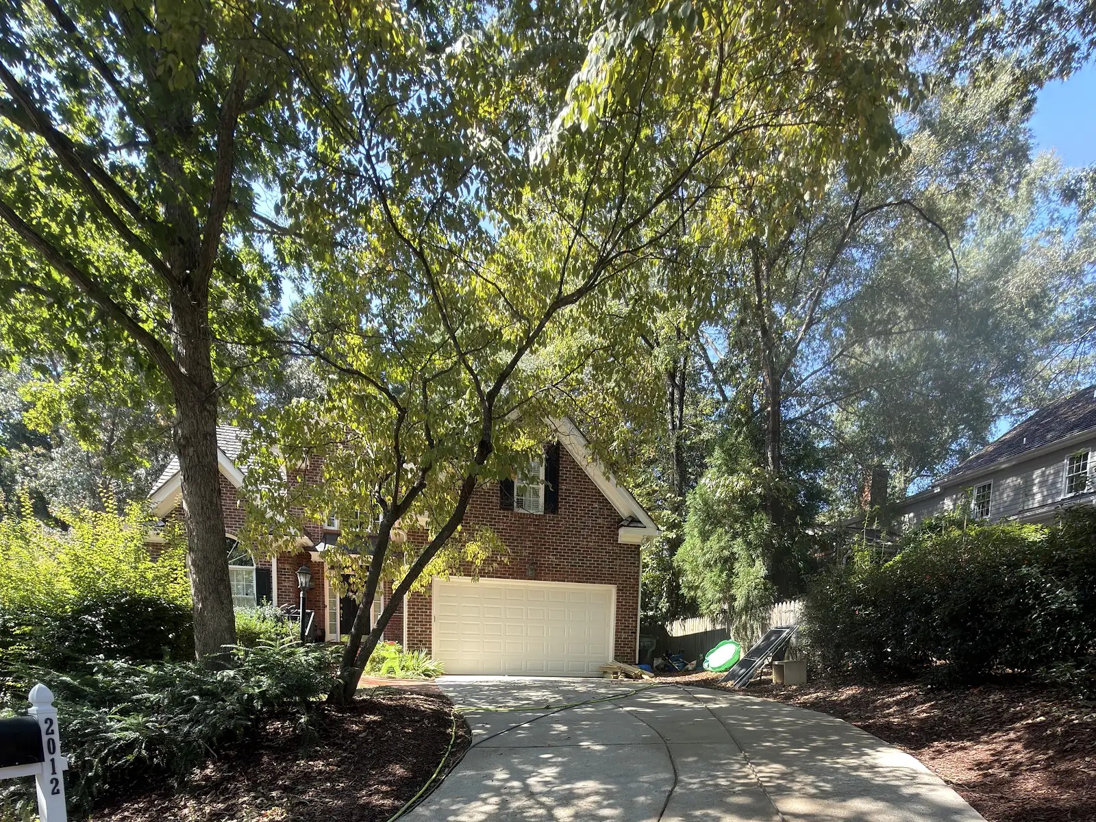 Green Eagle truck staged in a Cary NC neighborhood ready for a house and driveway wash